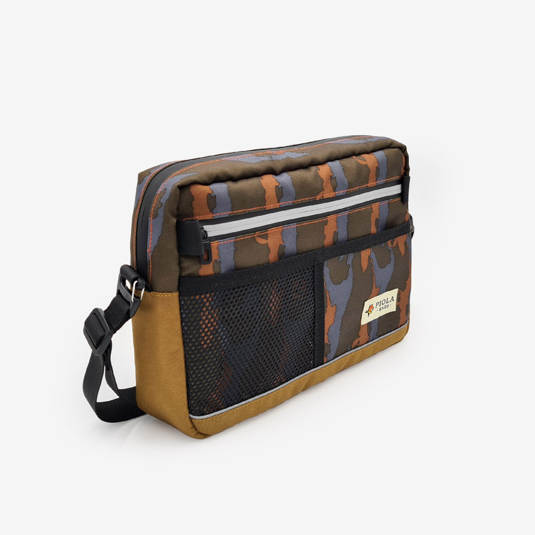 Morral camuflado con estilo urbano y bolsillo frontal de malla, diseñado con principios cruelty free por Piola Bags